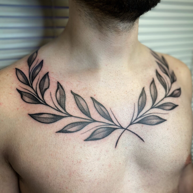 Bold linework chest tattoo by Zac